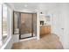 Bright bathroom showcasing a glass enclosed shower, double sinks, and tiled flooring at 21069 Woodside Ln, Parker, CO 80138