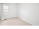 Bright bedroom featuring neutral carpet, white walls, and a window for ample natural light at 21069 Woodside Ln, Parker, CO 80138