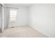 Bright bedroom featuring neutral carpet, white walls, and a window for ample natural light at 21069 Woodside Ln, Parker, CO 80138