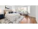 Light-filled bedroom with a bay window, wood floors, and coordinating furniture at 21069 Woodside Ln, Parker, CO 80138