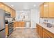 Well-lit kitchen with stainless steel appliances and wooden cabinets with a connecting breakfast nook view at 21069 Woodside Ln, Parker, CO 80138