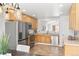 Modern kitchen with stainless steel appliances, light wood cabinets, and a passthrough at 21069 Woodside Ln, Parker, CO 80138