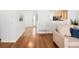 Inviting living space with hardwood floors leading to the front door and kitchen at 21069 Woodside Ln, Parker, CO 80138
