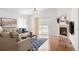 Inviting living room with fireplace, hardwood floors and patio doors leading to deck at 21069 Woodside Ln, Parker, CO 80138