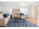 Bright living room featuring hardwood floors, modern decor, and comfortable seating arrangements at 21069 Woodside Ln, Parker, CO 80138