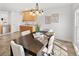 Cozy dining area with modern lighting and a view into the kitchen at 21069 Woodside Ln, Parker, CO 80138