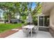 Cozy backyard patio featuring a table with umbrella and lush green lawn at 6581 E Heritage Pl, Englewood, CO 80111