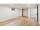 Finished basement with recessed lighting, wood flooring, a closet, and access to another room at 6581 E Heritage Pl, Englewood, CO 80111