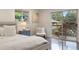 Bedroom with a sliding door to a balcony and view, light gray bedside table, and hardwood floors at 6581 E Heritage Pl, Englewood, CO 80111