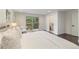Bedroom leading to a balcony with a view, with a bathroom featuring a soaking tub at 6581 E Heritage Pl, Englewood, CO 80111