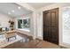 Bright entryway featuring a sleek front door, hardwood floors and a bay window at 6581 E Heritage Pl, Englewood, CO 80111