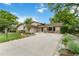 Charming ranch-style home with lush landscaping, stone accents and a large driveway at 6581 E Heritage Pl, Englewood, CO 80111