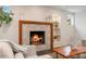Close up of a modern fireplace with decorative tile surround and built-in shelving at 6581 E Heritage Pl, Englewood, CO 80111