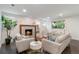 Inviting living room features a modern fireplace, neutral furnishings, and ample natural light at 6581 E Heritage Pl, Englewood, CO 80111