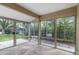 Bright sunroom with multiple glass windows and stone flooring offering serene views at 6581 E Heritage Pl, Englewood, CO 80111