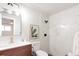 Stylish bathroom featuring modern vanity, toilet, and tiled shower with black fixtures at 1024 Stuart St, Denver, CO 80204