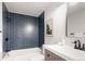 Modern bathroom featuring navy subway tile, matte black fixtures, and white vanity at 1024 Stuart St, Denver, CO 80204