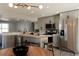 Open concept kitchen with stainless steel appliances, butcher block island, and modern lighting at 1024 Stuart St, Denver, CO 80204