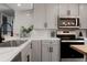 Modern kitchen features white cabinets, subway tile backsplash, stainless steel appliances, and black hardware at 1024 Stuart St, Denver, CO 80204