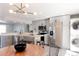 Open concept kitchen with stainless steel appliances, grey cabinets, butcher block island, and modern lighting at 1024 Stuart St, Denver, CO 80204