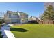 A spacious backyard with artificial turf, partially covered in snow, and a storage shed at 176 S Pembrook St, Castle Rock, CO 80104