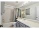Well-lit bathroom with a tub and shower combination and modern grey vanity at 176 S Pembrook St, Castle Rock, CO 80104