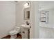 Cozy half-bath with pedestal sink, neutral paint and wood-look floor at 176 S Pembrook St, Castle Rock, CO 80104