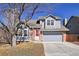 Charming two-story home featuring a well-maintained front yard and a gray painted facade and attached two-car garage at 176 S Pembrook St, Castle Rock, CO 80104
