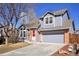 Charming two-story home featuring a well-maintained front yard and a gray painted facade and attached two-car garage at 176 S Pembrook St, Castle Rock, CO 80104