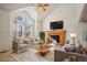 Inviting living room featuring vaulted ceilings and a cozy fireplace, bathed in natural light at 176 S Pembrook St, Castle Rock, CO 80104