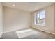 Neutral bedroom features carpet floors, a large window, and natural light at 6892 Huddersfield Ln, Castle Pines, CO 80108