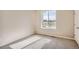 Bedroom with carpet floors, a bright window with outside view, and white trim at 6892 Huddersfield Ln, Castle Pines, CO 80108