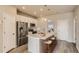 Modern kitchen featuring stainless steel appliances, sleek countertops, and a breakfast bar at 6892 Huddersfield Ln, Castle Pines, CO 80108