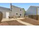 A spacious backyard featuring a patio seating area and fresh mulch at 19481 E Milan Cir, Aurora, CO 80013