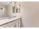 Bathroom featuring a white marble countertop vanity with a spacious mirror and lighting at 19481 E Milan Cir, Aurora, CO 80013