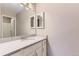 Bright bathroom featuring a marble countertop, sleek fixtures, and well-lit mirror with storage at 19481 E Milan Cir, Aurora, CO 80013