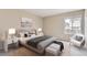 Well-lit bedroom with neutral colors, a comfortable bed, and ample natural light at 19481 E Milan Cir, Aurora, CO 80013