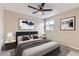 Stylish bedroom featuring a comfortable bed, contemporary decor, and a large window at 19481 E Milan Cir, Aurora, CO 80013