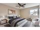 Inviting bedroom with a ceiling fan, neutral colors, stylish decor, and a comfortable bed at 19481 E Milan Cir, Aurora, CO 80013