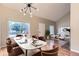 Inviting dining area with ample natural light and modern chandelier open to living space at 19481 E Milan Cir, Aurora, CO 80013