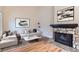 Bright living room with stone fireplace, wood floors, and modern decor creating an inviting space at 19481 E Milan Cir, Aurora, CO 80013