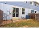 Backyard features sliding glass door, wooden fence, and air conditioning unit at 11149 Gaylord St, Northglenn, CO 80233