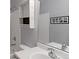 Updated bathroom featuring modern fixtures, stylish mirror, and white tiled accents at 11149 Gaylord St, Northglenn, CO 80233