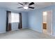 Comfortable bedroom featuring carpet, ceiling fan and ensuite bathroom at 11149 Gaylord St, Northglenn, CO 80233