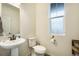 Clean and bright bathroom with pedestal sink and large window at 4343 S Nepal Ct, Centennial, CO 80015