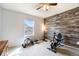 Bright bedroom with wood-look wall and exercise equipment at 4343 S Nepal Ct, Centennial, CO 80015