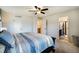 Bedroom with a striped comforter, ceiling fan, and access to bathroom at 4343 S Nepal Ct, Centennial, CO 80015