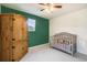 Charming Bedroom with crib and wooden armoire at 4343 S Nepal Ct, Centennial, CO 80015