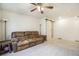 Spacious bedroom with a brown couch, ceiling fan and barn door at 4343 S Nepal Ct, Centennial, CO 80015
