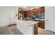 Modern kitchen features a large island, stainless steel appliances, and blue tile backsplash at 4343 S Nepal Ct, Centennial, CO 80015